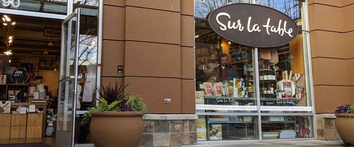 Kirkland, WA / USA - circa April 2020: Street view of a Sur La Table cookware store in downtown Kirkland, with customers shopping for kitchen supplies inside.