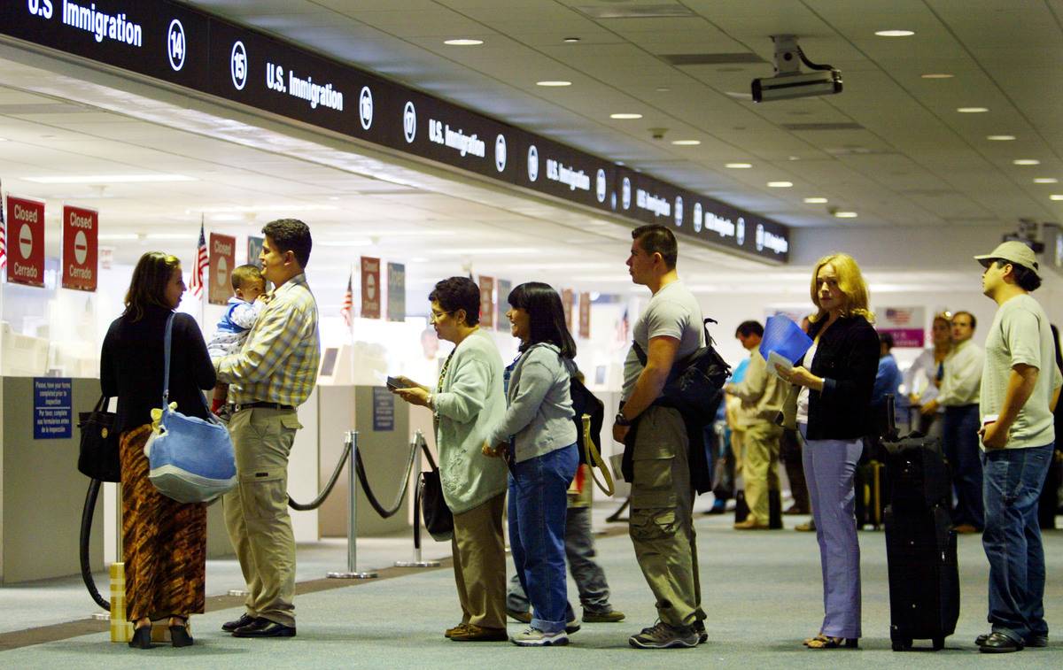 In Miami, people stand in line to be checked by Immigration inspectors.