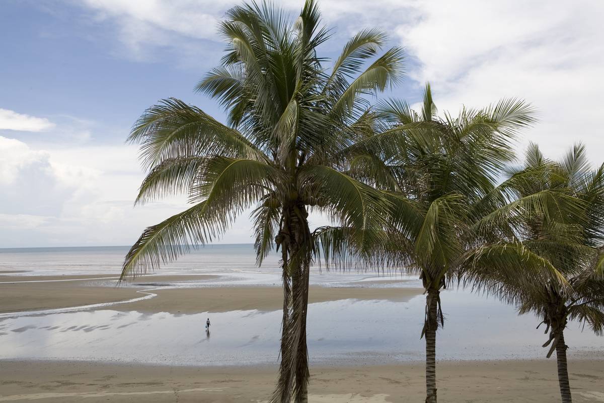 A single person is alone on a tropical beach.